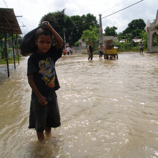 Boy standing in a flooded area