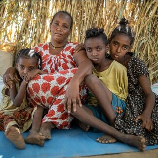 Woman and her children displaced due to conflict in Sudan