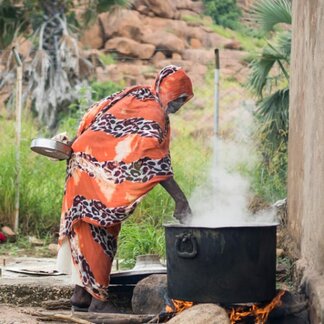 Woman cooking with fortified food items provided by WFP in response to acute malnutrition in Sudan